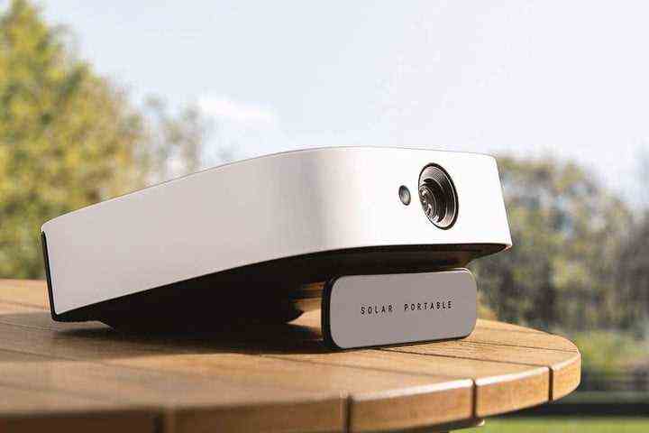 The Anker Nebula Solar projector on an outdoor table.