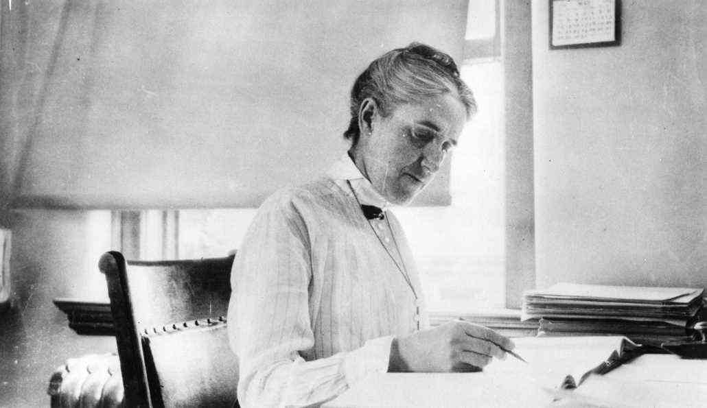 black and white image of Henrietta Leavitt sitting at a desk
