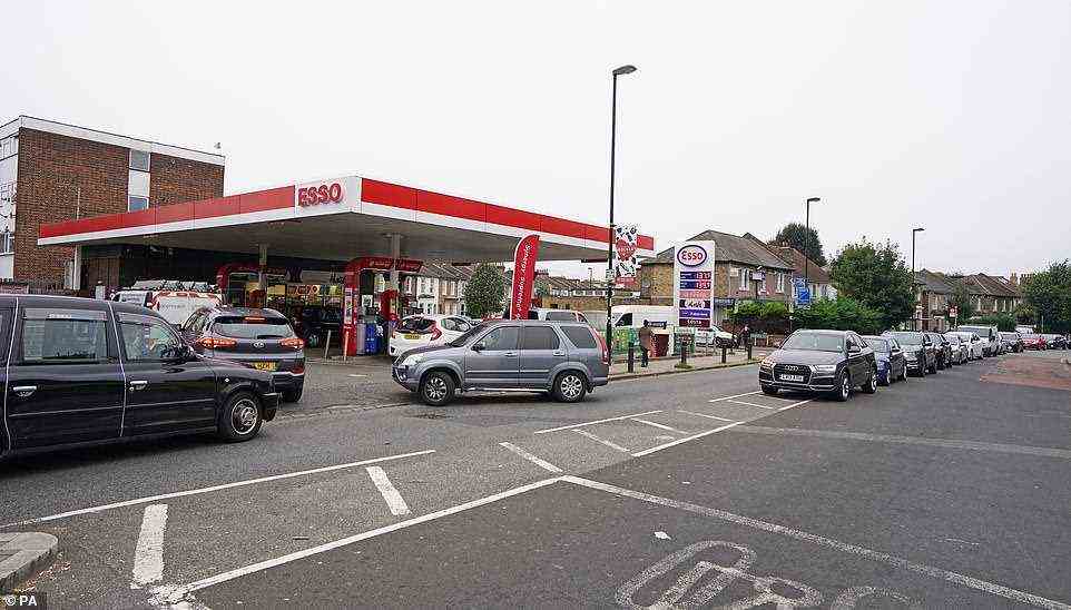 Motorists queue for petrol at an Esso petrol station in Brockley, South London, amid a shortage of drivers to bring the fuel to stations this weekend