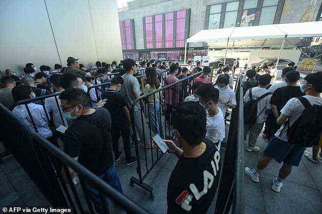 Customers queue to get newly-launched iPhone 13 mobile phones at an Apple store in Hangzhou, China