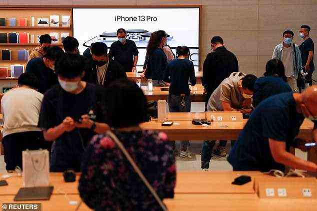 People are seen wearing face masks are at an Apple Store in Beijing, China, September 24