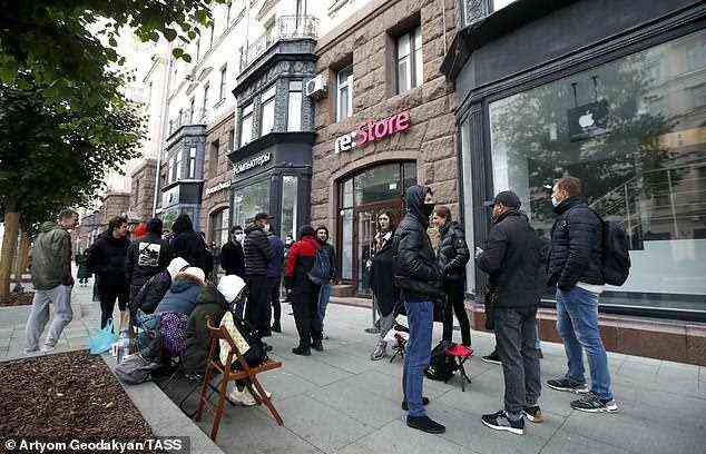 People gather outside the re:Store shop selling smartphones in Tverskaya Street Moscow, Russia