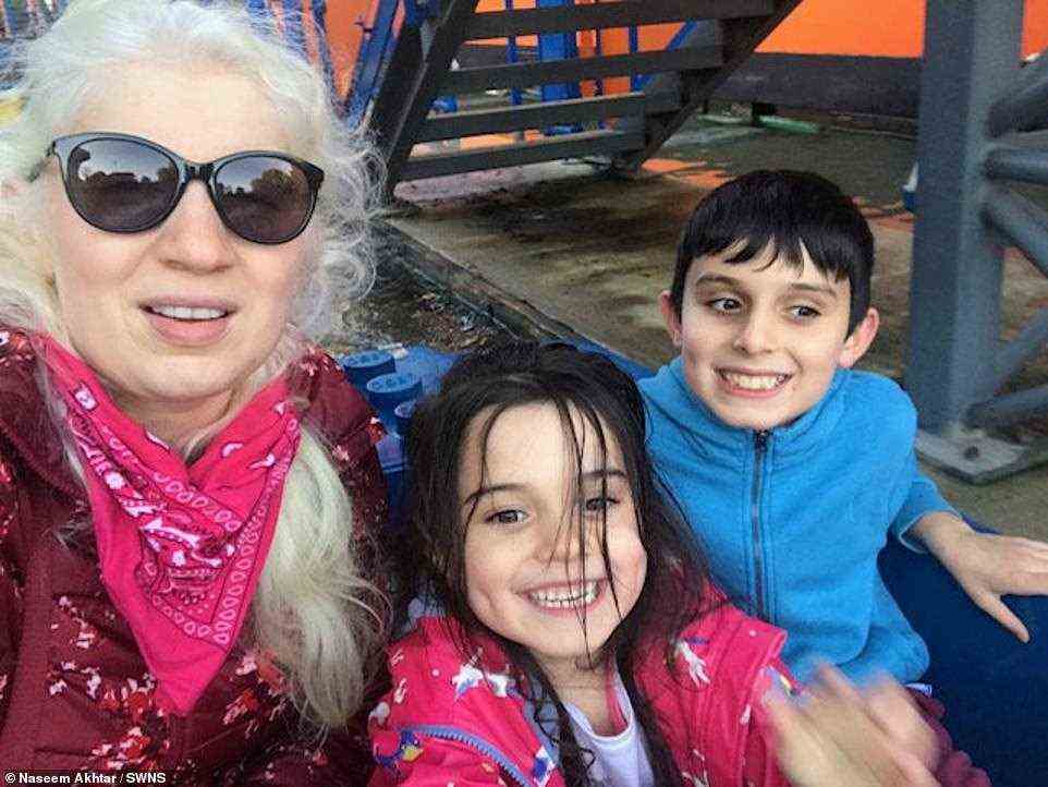 The family are awaiting confirmation from Guinness World Records, but believe they are the biggest family to all have albinism, beating the current record of four. Pictured, Naseem with two of her children