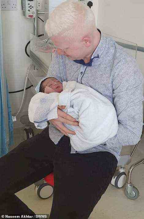 Pictured, Naseem's brother Mohammed, 27, with his son, who was born without oculocutaneous albinism