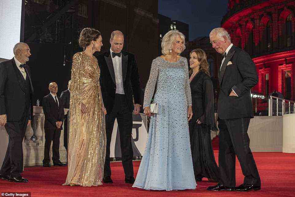 All smiles: The royal family was all smiles while lapping up the electric atmosphere at the Royal Albert Hall, along with Bond producers Michael G Wilson (left) and Barbara Broccoli (next to Charles)