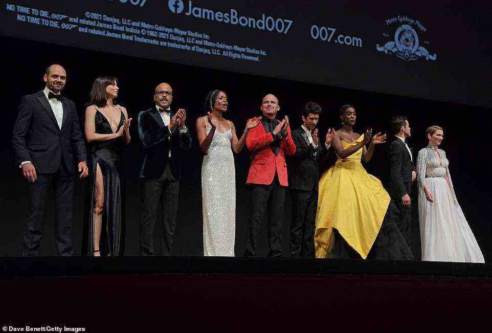Round of applause: After giving up the mic, Daniel was clapped by his fellow actors who seemed proud to be a part of such a highly-anticipated blockbuster