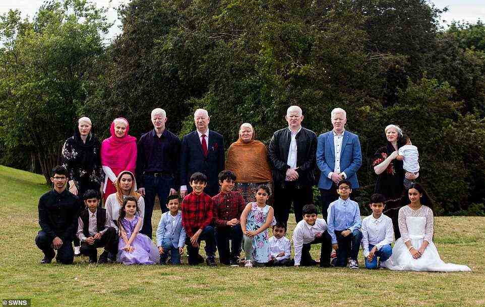 Back row, from left, Musarat Begum, Naseem Akhtar, Ghulam Ali, Aslam Parvez, Shameem Akhtar, Haider Ali, Mohammed Rafi, Muqadas Bibi, all of whom have albinism. Front row, from left, Ahmed aged 18, Asim aged 9, Sidra aged 20, Grace aged 6, Reharn aged 5, Oliver aged 9, Dylan aged 12, Khadija aged 8, Azmat aged 3, and Sadiq aged 9, Asad aged 11 Hussan aged 10 and Miryam aged 13 - all of whom do not have albinism. Albino members of the family not pictured: Naseem's brother's three children, as well as three nieces and nephews, born to non-albino parents