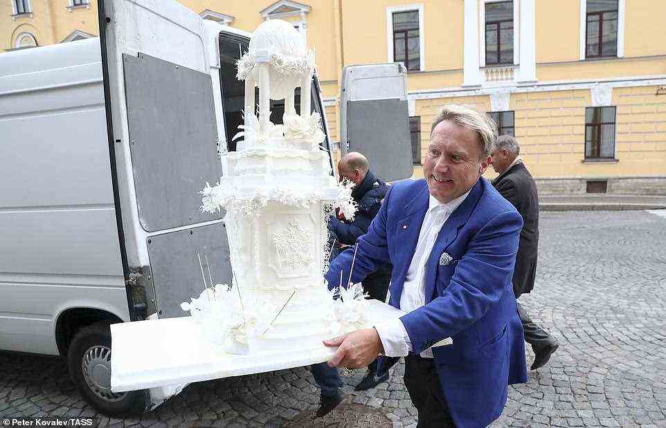 A cake mockup is delivered at the Russian Museum of Ethnography for a reception marking the wedding of Grand Duke George Mikhailovich of Russia, a descendant of the Romanov dynasty, and Rebecca (Victoria) Bettarini of Italy