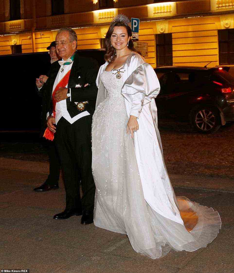 The bride later changed into a second stunning gown, a fairytale crystal embellished gown, with a satin coat featuring statement puffed sleeves over the top, as she arrived for the evening gala at the Russian Museum of Ethnography on the arm of her diplomat father Roberto Bettarini