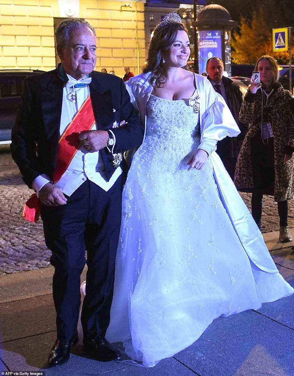 Victoria Romanovna Bettarini accompanied by her father, Roberto Bettarini, arrives to attend a dinner after her wedding with Grand Duke George Mikhailovich Romanov in Saint Petersburg