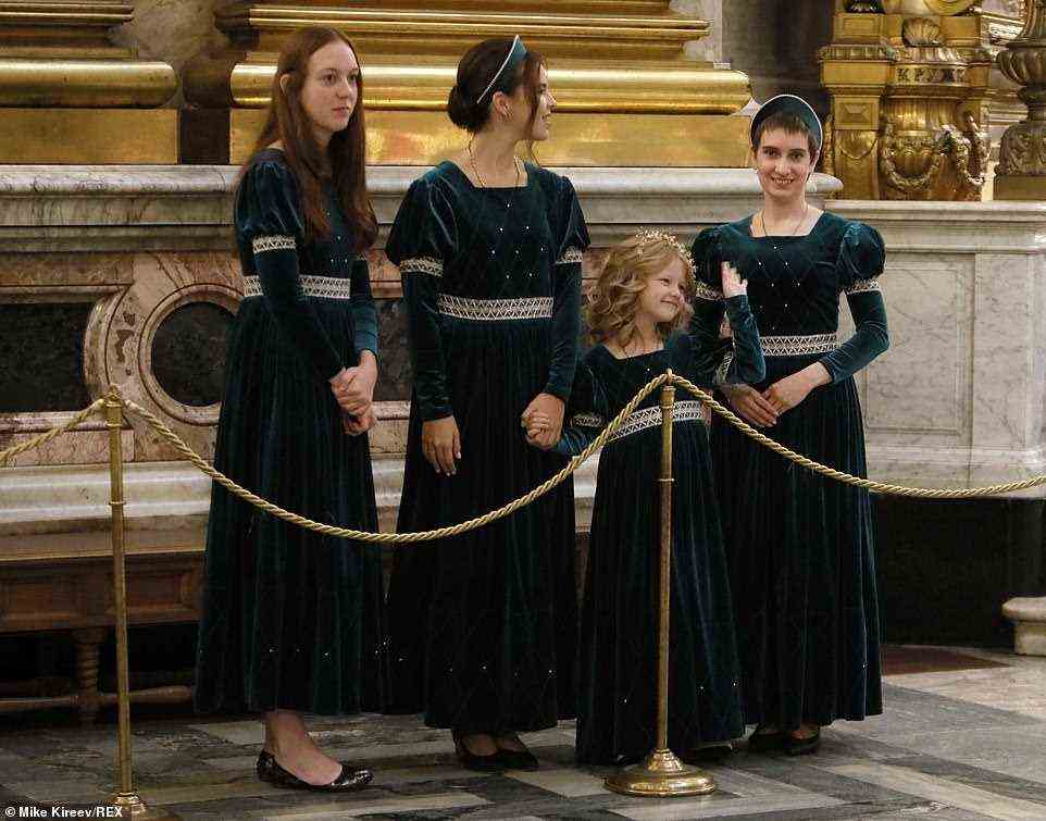 Meanwhile bridesmaids at the event opted for a velvet green dress with medieval style puff sleeves (pictured together)