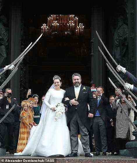 Rebecca and Grand Duke George Romanov beamed as they walked out of the cathedral arm-in-arm after tying the knot