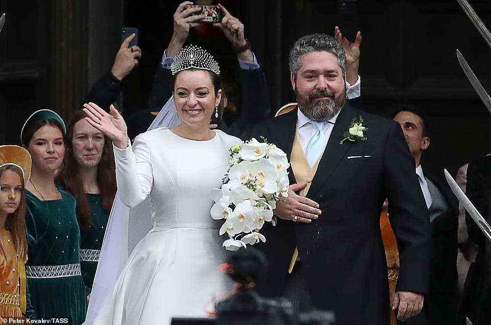 Rebecca beamed widely as she waved to crowds waiting outside the cathedral shortly after the wedding with Grand Duke George