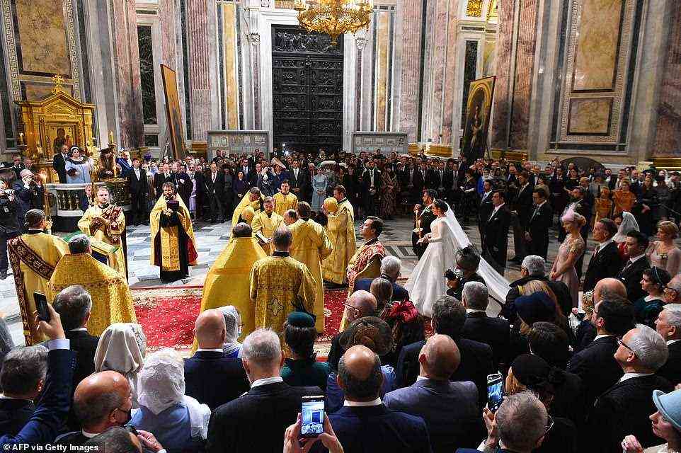 The pair were surrounded by friends and family as they walked down the aisle at the wedding at Saint Isaac's Cathedral in Saint Petersburg