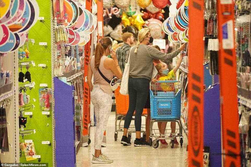 The family was also pictured shopping inside a Party City and filling up a small cart