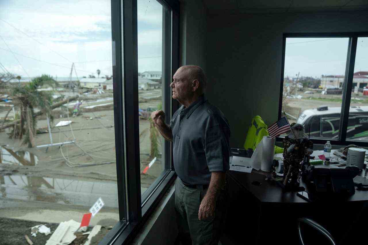 Police Chief Scooter Resweber looking out the window in his office on Grand Isle, where he and his officers took shelter during Hurricane Ida.