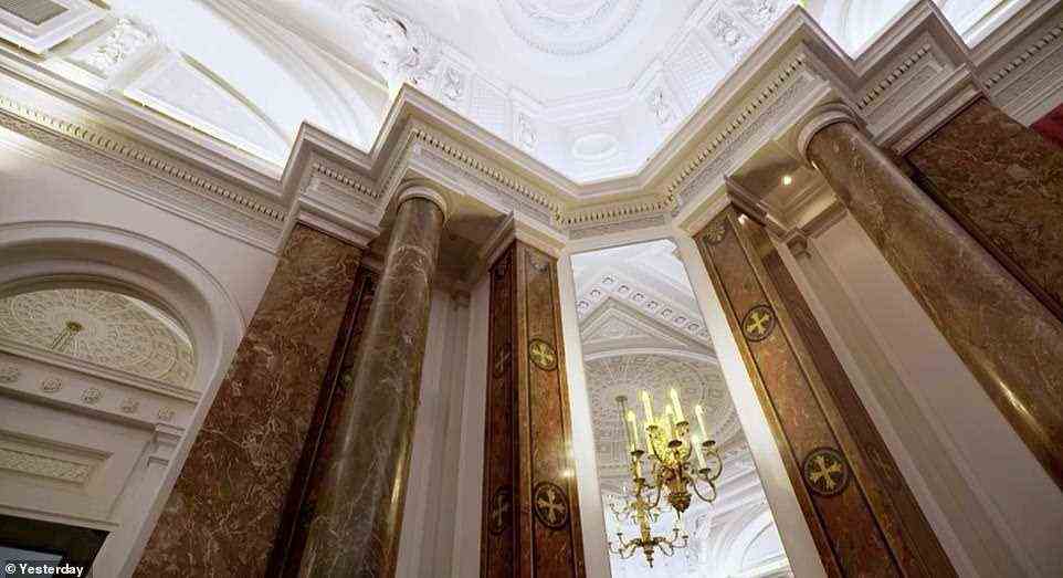 Above: The Tuscan-inspired marble pillars rise up to a bright white ceiling which is decorated with octagonal patterns