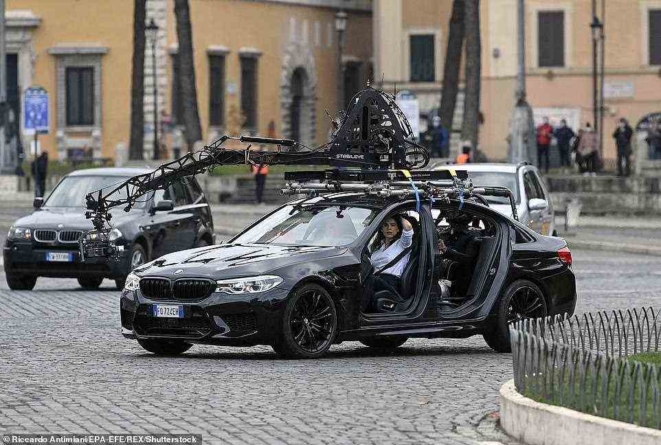 Tom Cruise with actress Hayley Atwell in a car during filming at Rome's Piazza Venezia