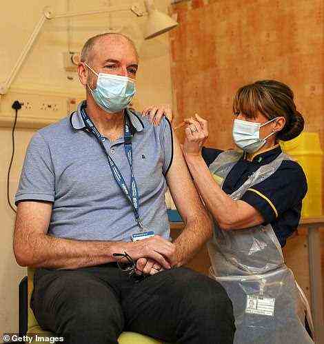 The report concluded that the vaccine programme was ‘one of the most stunning scientific achievements in history’ and that it ‘redeemed’ many of the UK’s other policy failings. Pictured: Professor Andrew Pollard receives the AZ vaccine in January