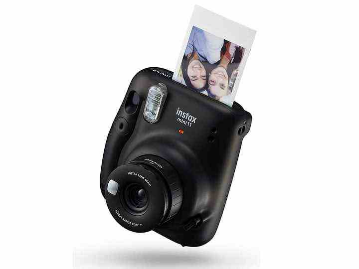The black version of Fujifilm's Instax Mini 11 while developing a picture.