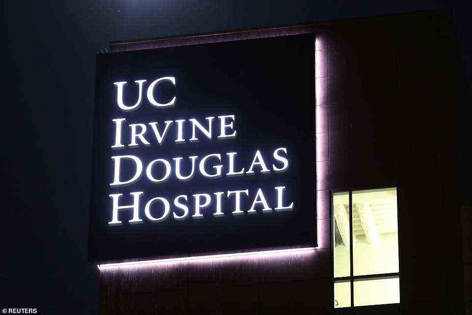 The hospital sign is lit up on Thursday night, as Clinton remains in their ICU ward