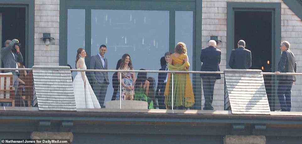 Beaming bride Jennifer Gates and her dashing groom stepped out on the deck of their home to enjoy a quiet moment on Friday with her recently divorced parents Bill and Melinda Gates, and her little brother
