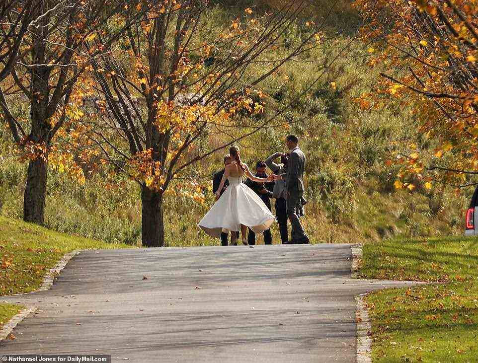 Gates wore an elegant white bridal dress while the groom wore a grey suit for the couple's pre-wedding photos on Friday