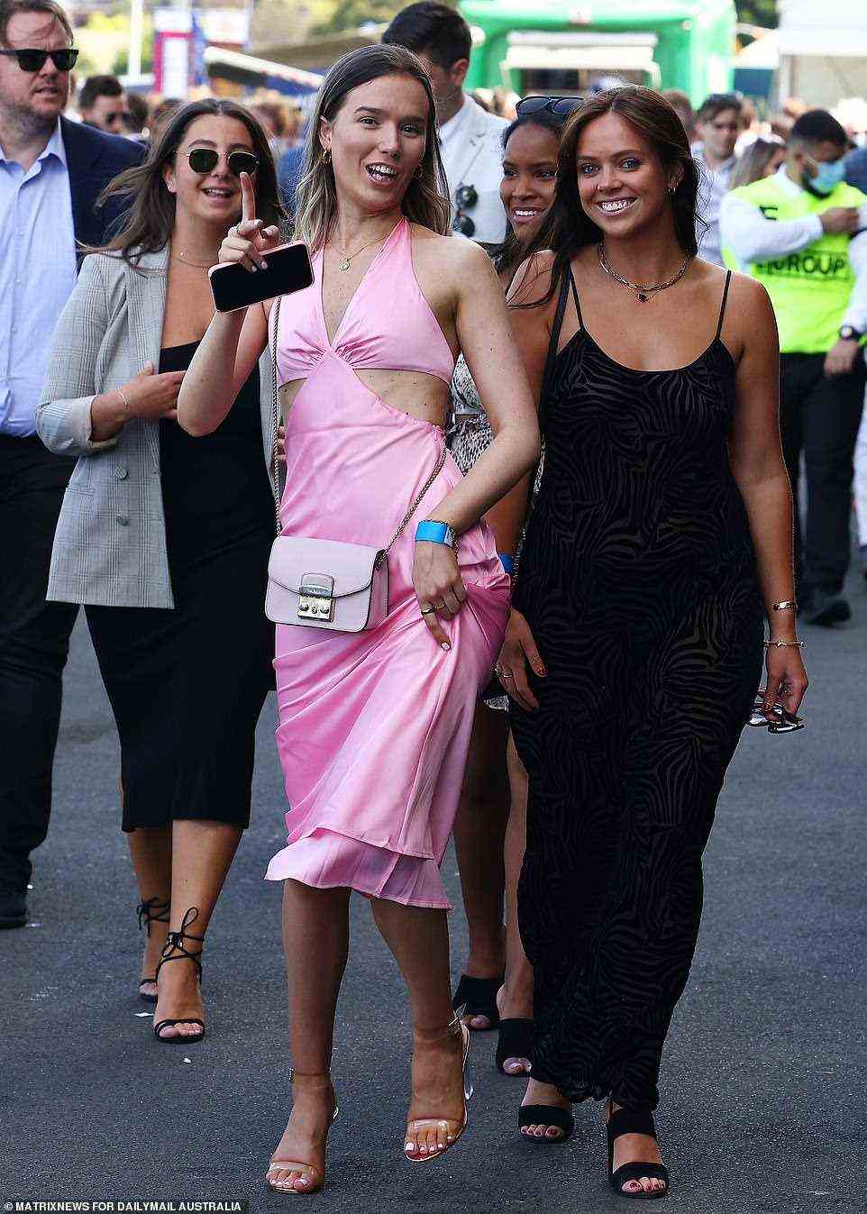 A group of friends are seen strutting their stuff as they head into the Royal Randwick Racecourse