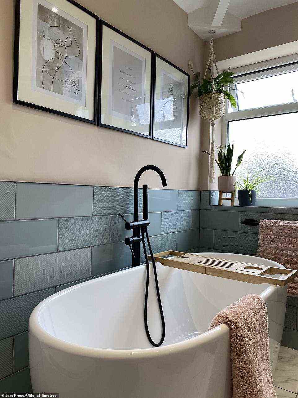 The couple decorated their new bathroom with artworks and plants to make it a cosy relaxing room, perfect for a soak after a busy week, pictured