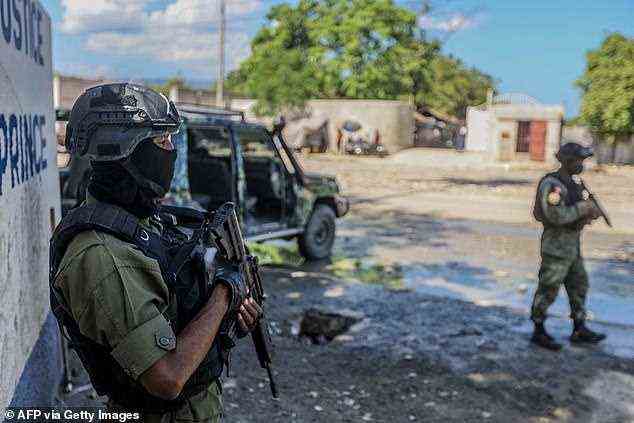 As many as 17 Christian Missionaries from the United States have been kidnapped by a gang on Saturday in Port-au-Prince, Haiti. Pictured, soldiers guard the Public Prosecutor's office in Port-au-Prince (file photo)
