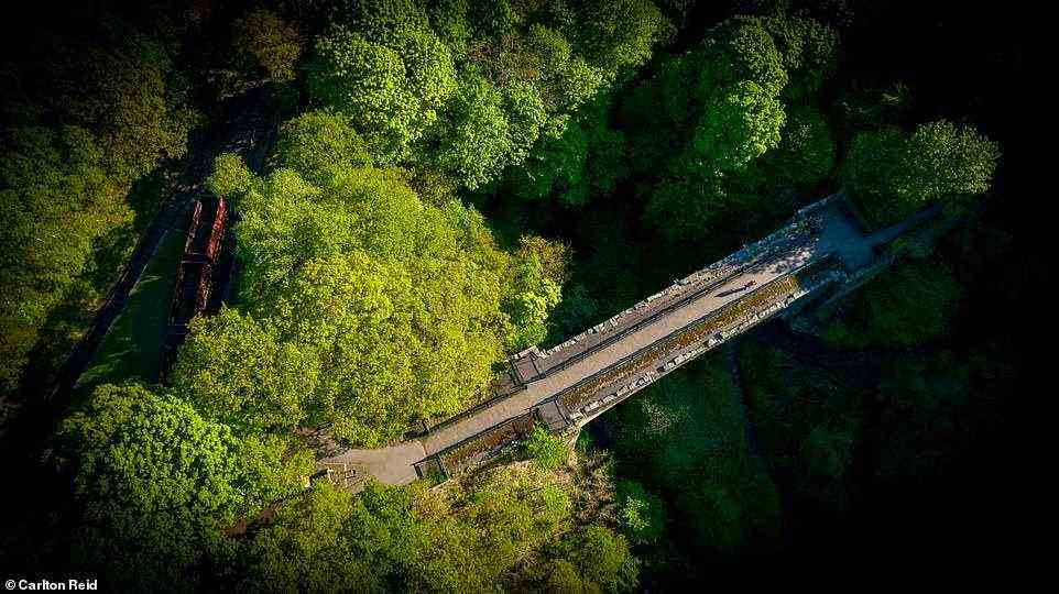 A bird's eye view over Causey Arch, with railway coal wagons to the left. The railway bridge was built more than 100 years before the first steam locomotives