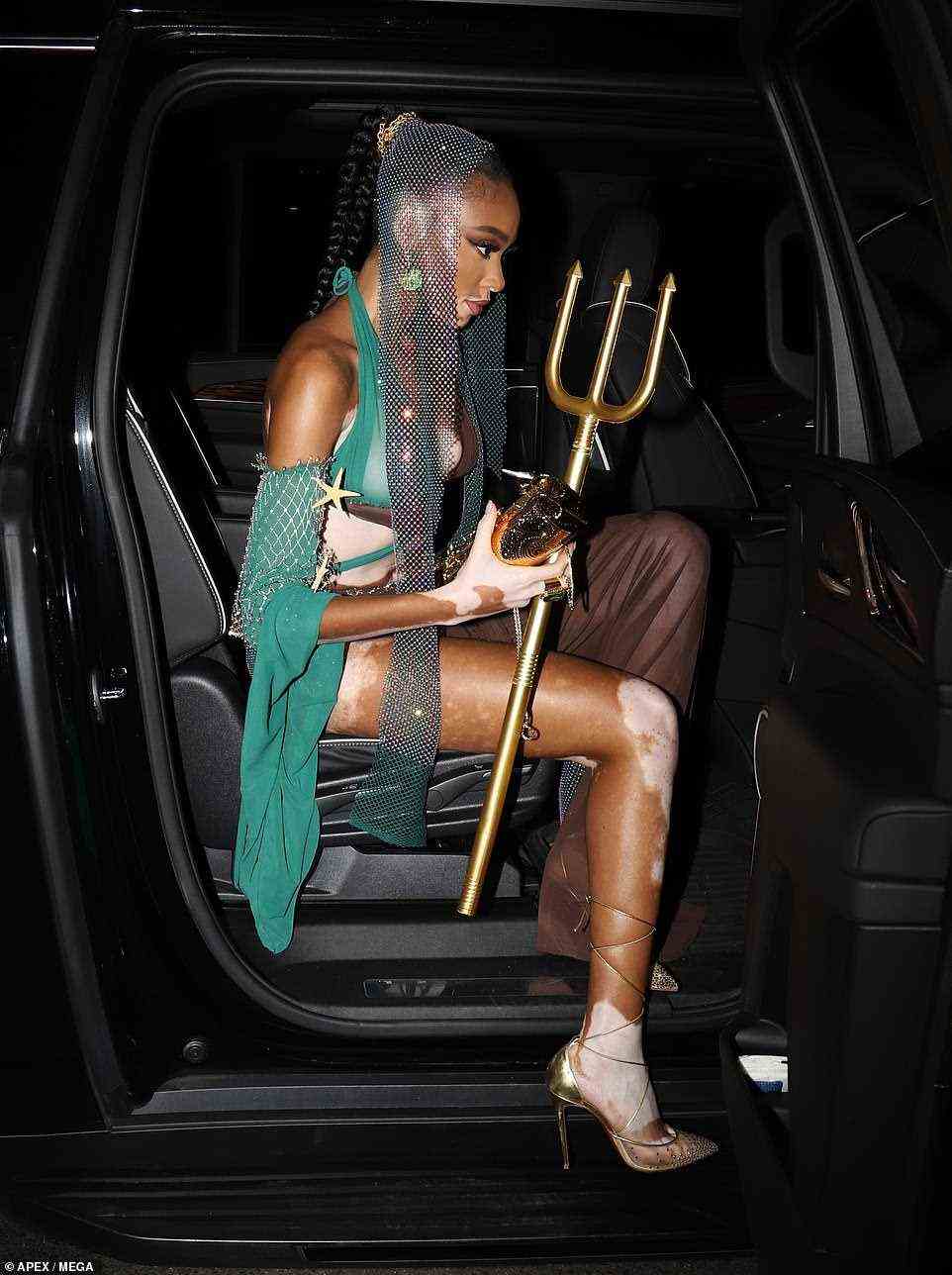 Stylish: Winnie looked ethereal as she stepped out of a blacked-out vehicle