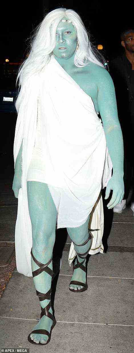 Confident: Model Shaun Ross demanded attention as he strutted into the venue wearing turquoise skin-paint, which he accented with a white toga