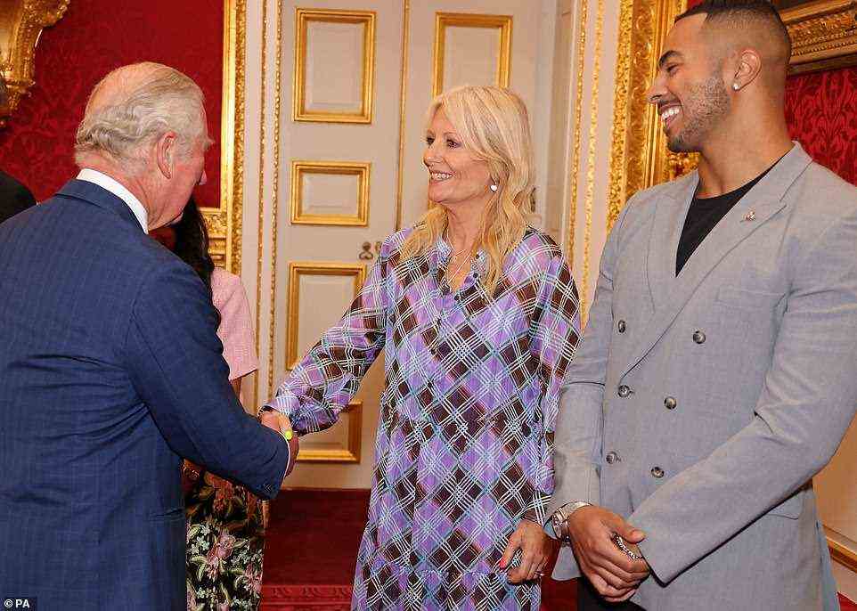 A smiling Gaby Roslin shook hands with Prince Charles while Tyler West awaited his turn