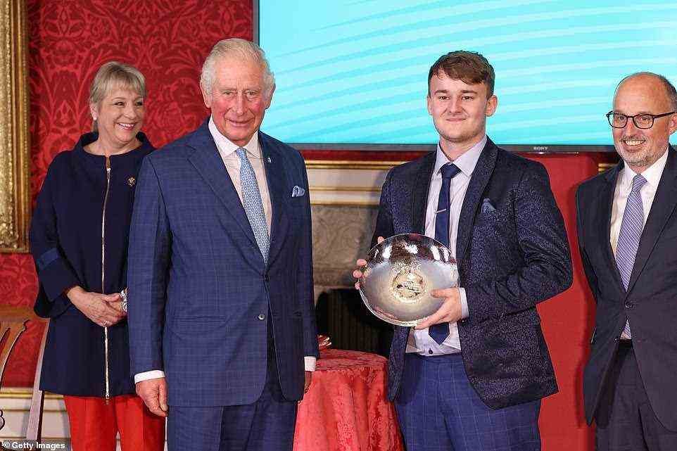 A beaming Aidan Sayers poses next to Prince Charles with his Ascential Educational Achiever Award