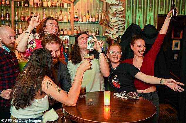 Overjoyed Melbourne residents savoured their first drink in a pub since August as the city's lockdown lifted (pictured)