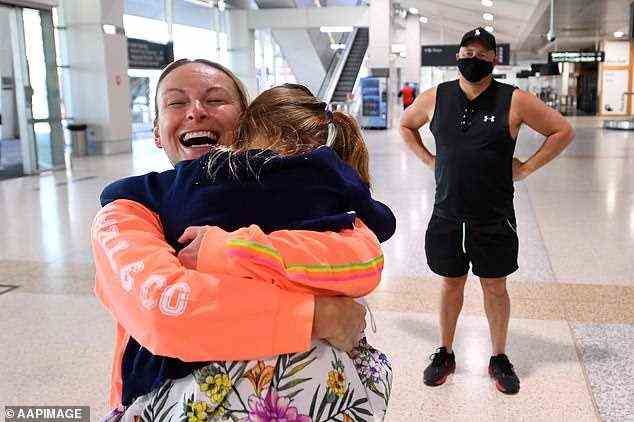 A mother and daughter are reunited at Melbourne Airport on Wednesday. Fully-vaccinated Australian travellers from overseas will no longer be required to isolate upon arrival in Victoria from November 1