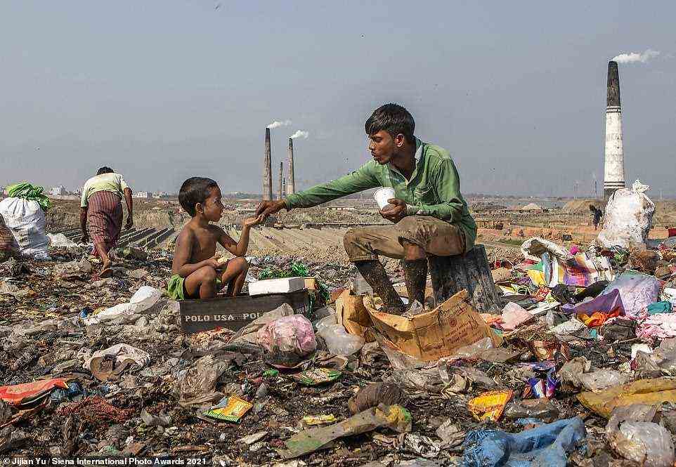 Photographer Jijian Yu revealed little about the location of this image, simply explaining: 'A father is feeding his little boy in the middle of a rubbish dump.' It was shortlisted in the Journeys & Adventures category