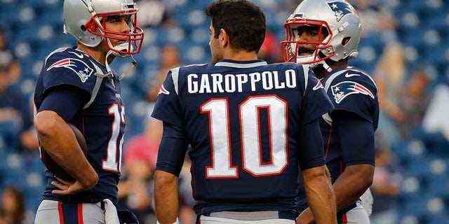 Jimmy Garoppolo (10), Jacoby Brissett (7) und Tom Brady (12) von den New England Patriots unterhalten sich im August 2017 vor einem Vorsaisonspiel mit den New York Giants im Gillette Stadium.