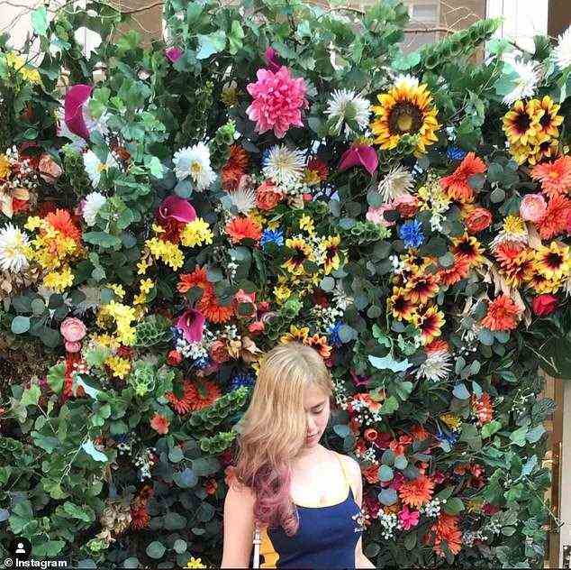 Businesses from all around the UK are using popular floral displays to seduce their clientele and appear more Instagram-friendly. Pictured, the flower wall at Dominique Ansel Bakery in London