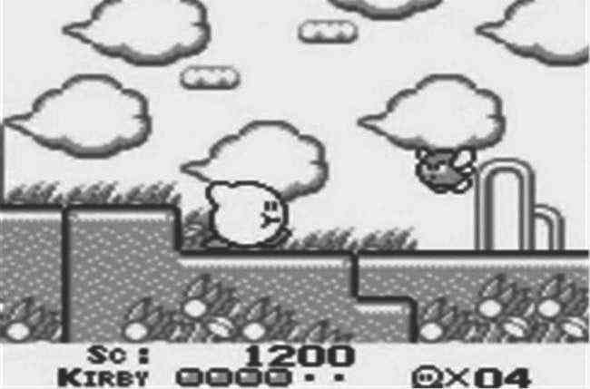 Kirby running through a field with something in his mouth.