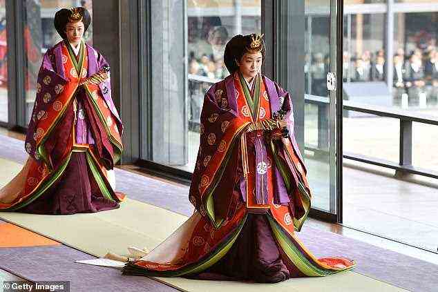 High profile: Princess Mako of Japan, right, the eldest daughter of Crown Prince Fumihito, donned a traditional Jūnihitoe as she took part in a procession through Tokyo's Imperial Palace to mark her uncle's formal ascension to the Chrysanthemum Throne in 2019
