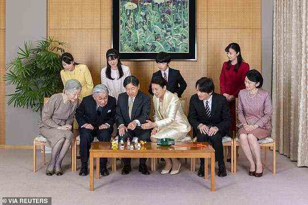 Japan's Emperor Naruhito, seated third from left, and Empress Masako, seated third from right, pose with their family members for a family photo, including Mako (standing, far left)