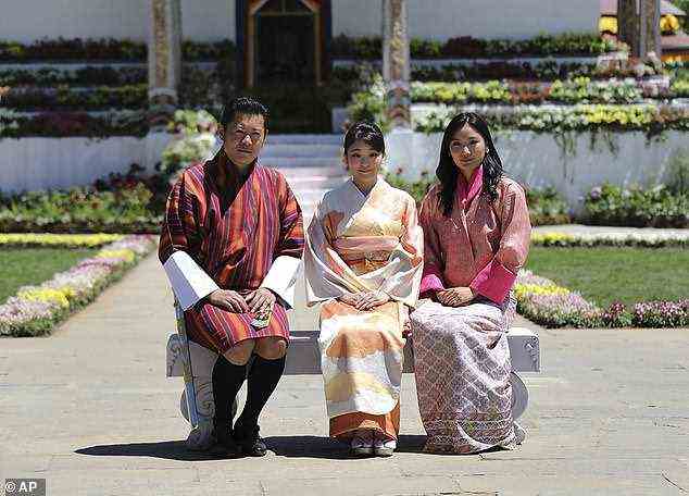 Japan's Princess Mako, center, the granddaughter of Emperor Akihito, is flanked by Bhutan's King Jigme Khesar Namgyal Wangchuck, left, and Queen Jetsun Pema, right, as they pose at the Royal Bhutan Flower Exhibition in Paro, Bhutan, Sunday, June 4, 2017