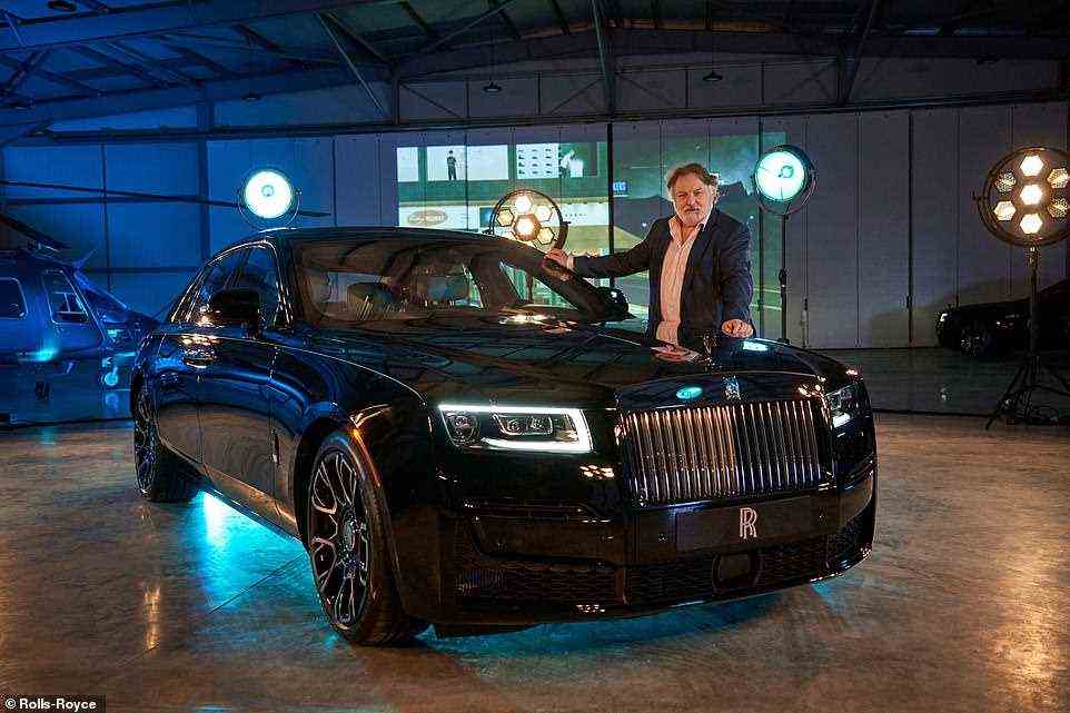Daily Mail's Ray Massey poses with the new Rolls-Royce Black Badge Ghost as he got an sneak peak and drive of the new car ahead of today's unveiling