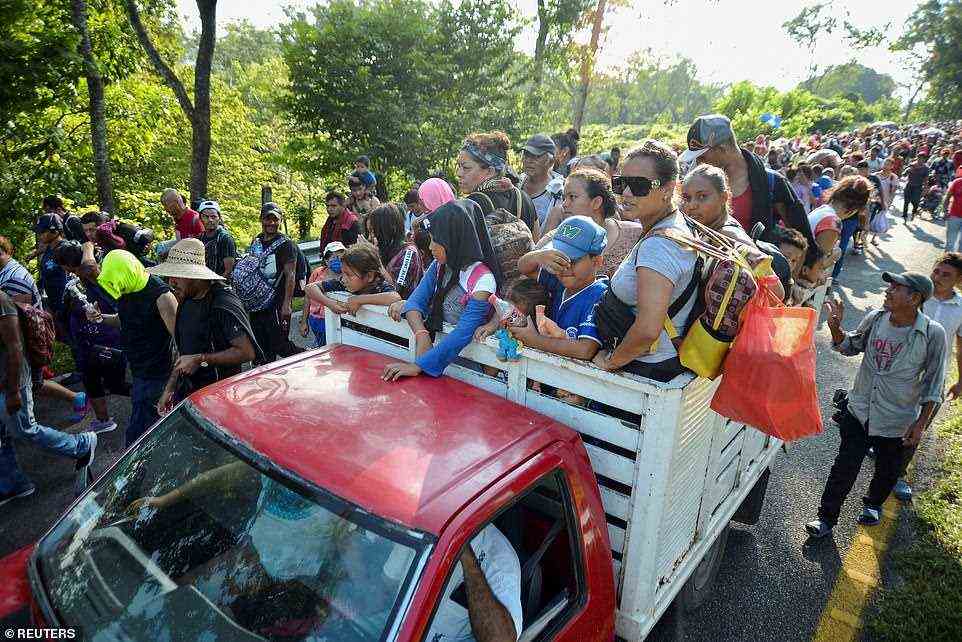 Migrants crammed together on the flat bled of a pickup truck as a caravan was traveling through the southern Mexican state of Chiapas on Thursday. The group, about 5,000 in total, was in the middle of a 10-mile trip from Villa Comaltitlán to Escuintla