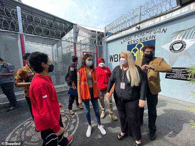 Mack talks to prison officials as she prepares to step outside the prison gates on Friday