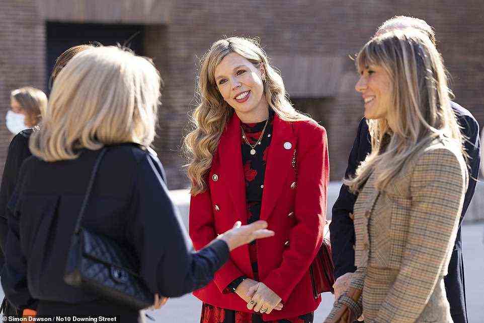 Carrie is seen with Brigitte Macron and the wife of Spanish Prime Minister Pedro Sanchez, Begona Sanchez, looked stunning in a plaid cropped blazer, matching flared pleated skirt and nude sock boots