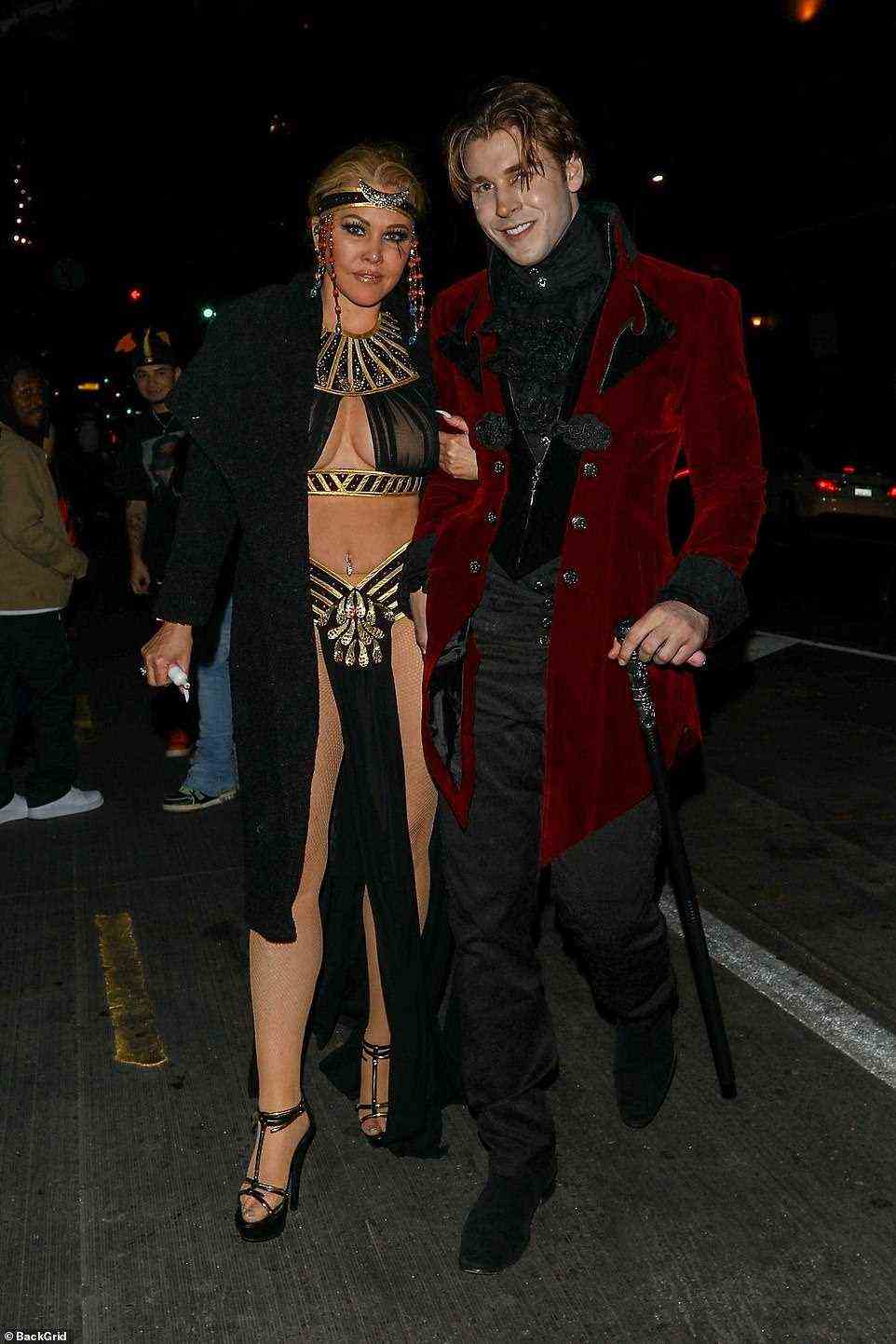 Out and about: The 46-year-old former pageant queen showed off her gym-honed figure in a sexy Egyptian queen costume while Matthew, 29, opted for a vampire disguise for a wild night out on the town following her exes engagement news