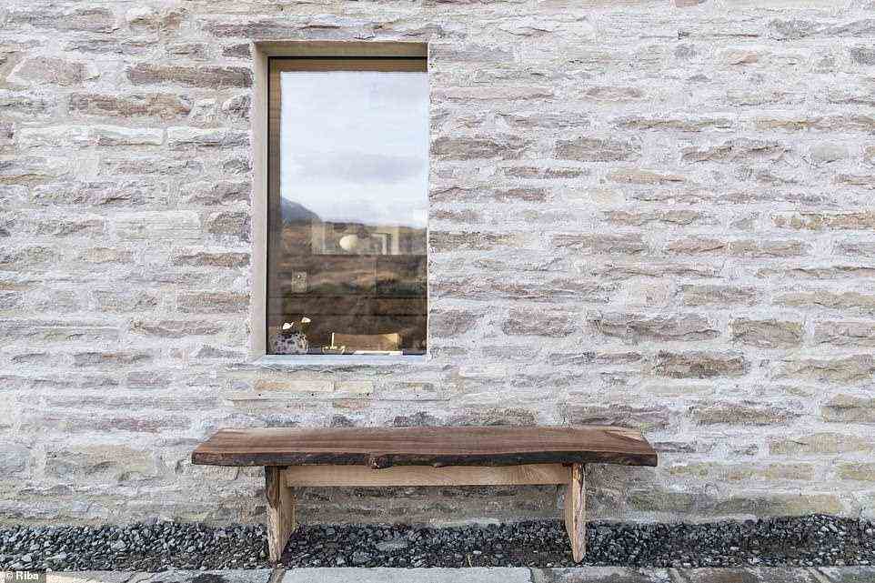 Outside the house is decorated with a simple wooden bench to allow those staying at the holiday cottage to enjoy the outside space and country air